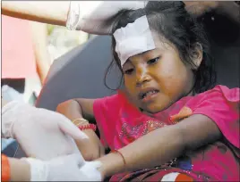  ?? Firdia Lisnawati ?? The Associated Press A girl injured in an earthquake is treated Thursday in Mataram, Indonesia.