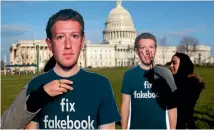  ?? PHOTO: AP ?? Sofia Latif, right, and Nell Greenberg of the advocacy group, Avaaz, install lifesized cutouts depicting Facebook chief executive Mark Zuckerberg wearing "Fix Fakebook" T-shirts on the southeast lawn of the Capitol in Washington yesterday.