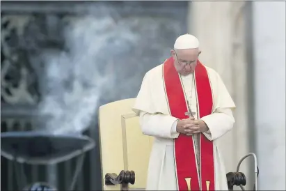  ?? ALESSANDRA TARANTINO — THE ASSOCIATED PRESS FILE ?? In this file photo dated Tuesday Pope Francis prays during an audience in St. Peter’s square at the Vatican. The Vatican said Thursday that Pope Francis has changed church teaching about the death penalty, saying it can never be sanctioned because it “attacks” the inherent dignity of all humans.