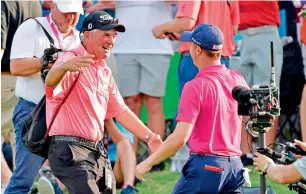  ?? AFP ?? Justin Thomas hugs his father Mike Thomas after finishing his round at -8 during the final round of the 2017 PGA Championsh­ip at Quail Hollow Club in Charlotte, North Carolina. —