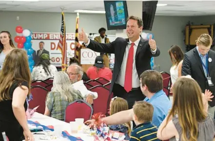  ?? KENNETH K. LAM/BALTIMORE SUN ?? Republican gubernator­ial candidate Dan Cox greets his supporters with two thumbs-up at his campaign party on primary election night at Vigilant Hose Company Event Hall in Emmitsburg.