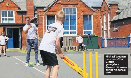  ??  ?? Michael Vaughan puts one of the Cestria youngsters through his paces during his school visit