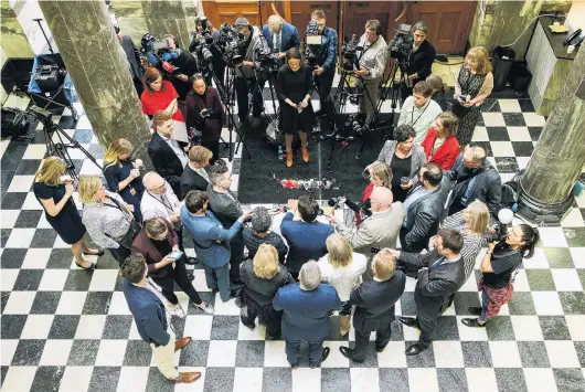  ?? PHOTO: GETTY IMAGES ?? United front . . . Surrounded by senior National Party MPs, party leader Simon Bridges speaks to media after a caucus meeting at Parliament yesterday.