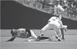  ?? TOMMY GILLIGAN/USA TODAY SPORTS ?? Diamondbac­ks left fielder Tim Locastro (16) slides through the plate after being tagged out by Nationals second baseman Starlin Castro (13) during the third inning at Nationals Park.