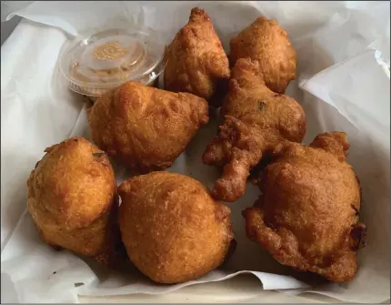  ?? (Arkansas Democrat-Gazette/Eric E. Harrison) ?? The enormous, puffy hush puppies are on the veggie/vegan and omnivore sides of Esters’ menu.