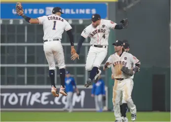  ?? AP PHOTO ?? Houston Astros players Carlos Correa and George Springer celebrate winning Game 3 of the World Series against the Los Angeles Dodgers on Friday in Houston. The Astros won 5-3 to take a 2-1 lead in the series.