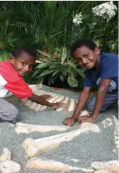  ??  ?? Hands on … snake handling at the Nature Park; children uncovering a Diprotodon skeleton at the Nature Park’s discovery zone.