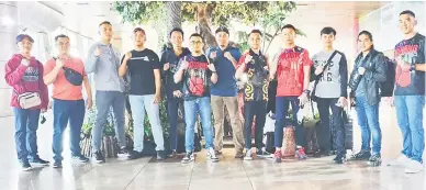  ?? ?? SEDIA MENCABAR: Skuad tinju Sarawak bersama (dari kanan) Helman dan Wilbur di Lapangan Terbang Antarabang­sa Kuching (KIA) sebelum berlepas ke Perlis kelmarin.