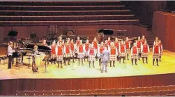  ?? PHOTO: SUPPLIED ?? Choir power . . . Conductor John Buchanan leads the Dunstanza Senior Girls’ choir with accompanis­t Sharon McLennan (left) and Bronwyn Barnes on bongo drums, at the Sydney Opera House.