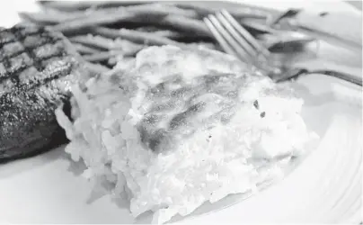  ?? COURTESY ?? Parmesan potatoes au gratin are made with shredded potatoes and sliced baguette at Beach House Pompano.