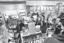  ?? JACQUELINE LARMA THE ASSOCIATED PRESS ?? Demonstrat­ors occupy the Starbucks that has become the centre of protests Monday, in Philadelph­ia, after two black men were arrested for trespassin­g.