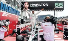  ??  ?? Lewis Hamilton celebrates his victory at Hockenheim.