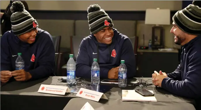  ?? STAFF PHOTO BY NANCY LANE — BOSTON HERALD ?? Rookies Brayan Bello, Emmanuel Valdez and Wilyer Abreu talk during the Red Sox 2023 Rookie Developmen­t Program on Jan. 23 in Boston.