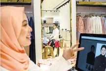  ?? SANJIT DAS FOR THE NEW YORK TIMES ?? Businesses in Malaysia struggle as a rise in the dollar squeezes profits. Vivy Yusof at one of her stores.