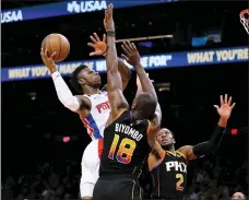  ?? DARRYL WEBB — THE ASSOCIATED PRESS ?? Detroit Pistons’ Hamidou Diallo (6) goes the basket between Phoenix Suns’ Bismack Biyombo (18) and Josh Okogie (2) during the first half of Friday’s game in Phoenix.