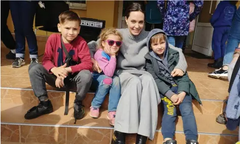  ?? Reuters ?? Oscar-winning actress and UNHCR special envoy Angelina Jolie with children in the western Ukrainian city of Lviv