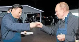  ?? TASS/EPA ?? China’s President Xi Jinping and Russia’s President Vladimir Putin toast at the Far East Street exhibition at the Eastern Economic Forum in Vladivosto­k, Russia.