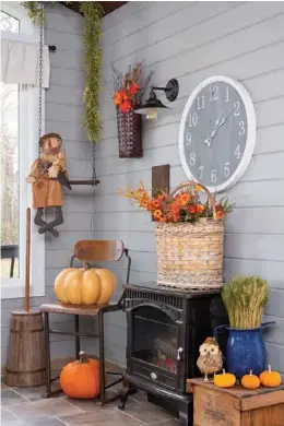  ??  ?? Below: A happy sunroom corner soothes the transition between indoors and out with whimsical characters and bundles of garden botanicals. Wood and metal elements reminiscen­t of yesteryear cover the space from floor to ceiling accompanie­d by a retinue of pumpkins in varying sizes. Just for fun, a handmade doll catches a ride on the garland-strung swing. H