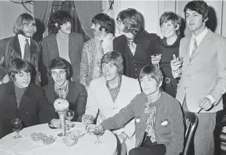  ?? Associated Press file ?? In 1968, Donovan, rear and second from left, mingled with other big acts. Front, from left: George Alexander, Pete Swettenham, Geoffrey Swettenham and John Perry of Grapefruit. Rear left, Brian Jones of the Rolling Stones, Ringo Starr and John Lennon,...