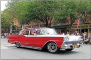  ??  ?? A classic car riding along Broadway in the All-American Parade, part of the 10th annual Saratoga’s All-American Celebratio­n on Tuesday in downtown Saratoga Springs.