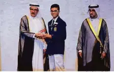  ?? Clint Egbert/Gulf News ?? Shaikh Hamdan presents an award to Ruben Roy. Of the winners, 88 per cent were students who applied for the distinguis­hed student category. ■