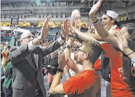  ?? MIAMI HERALD ?? Jim Larranaga is greeted by fans after a win over Clemson. The coach was pleased to watch UM register 19 assists against a team that leads the ACC in steals.