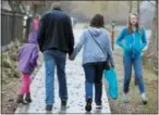  ?? RICK BOWMER — THE ASSOCIATED PRESS ?? Amy Coulter, center right, and her husband Mark walk together with their children April, 7, left, and Kendra, 12, at the Place Heritage Park in Salt Lake City.