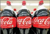  ?? ?? Bottles of Coca-Cola are on display at a grocery market in Uniontown, Pennsylvan­ia. (AP)