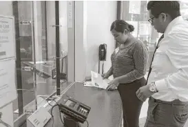  ?? Mark Mulligan / Houston Chronicle ?? Alejandra Garcia, 19, files paperwork with the Deer Park Police Department regarding the detention of her mother, Lucia Montes.