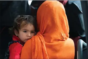  ?? AP PHOTO BY JOSE LUIS MAGANA ?? Families evacuated from Kabul, Afghanista­n, wait to board a bus after they arrived at Washington Dulles Internatio­nal Airport, in Chantilly, Va., on Friday, Aug. 27.