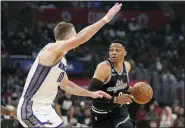  ?? MARK J. TERRILL — THE ASSOCIATED PRESS ?? Los Angeles Clippers guard Russell Westbrook, right, drives by Sacramento Kings forward Domantas Sabonis during the first half of an NBA basketball game on Friday night.