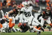  ?? A.J. MAST — THE ASSOCIATED PRESS, FILE ?? The Raiders’ Josh Jacobs (28) runs during the first half of a wild-card playoff game against the Bengals on Jan. 15in Cincinnati. The Raiders declined Jacobs’ fifth-year option.