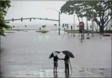  ?? HOLLYN JOHNSON — HAWAII TRIBUNE-HERALD VIA AP, FILE ?? In this file photo, people stand near flood waters from Hurricane Lane in Hilo, Hawaii.