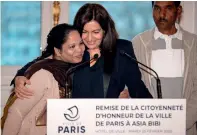  ?? AFP ?? FRENCH HONOUR: Asia Bibi is awarded the honorary citizenshi­p of Paris by Mayor of Paris Anne Hidalgo at the city hall. —