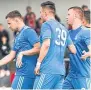  ??  ?? Greg Stewart, left, celebrates his goal with Miles Storey and Adam Rooney.