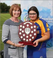  ??  ?? Captain Jenny Tyrrell accepts the trophy from Camogie Associatio­n President Kathleen Woods after Wicklow’s win in the All-Ireland Under-16 Camogie Progress to Success final at Abbotstown on Saturday. Photo: Dave Barrett