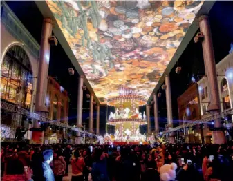  ??  ?? January 1, 2014: The Place, a shopping mall featuring a striking projection screen in the Central Business District of eastern Beijing, attracts a huge crowd to celebrate the New Year. VCG