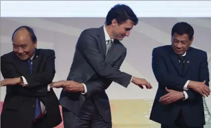  ?? ADRIAN WYLD, THE CANADIAN PRESS ?? Prime Minister Justin Trudeau shakes hands with Vietnamese Prime Minister Nguyen Xuan Phuc, left, and Philippine President Rodrigo Duterte on Tuesday.