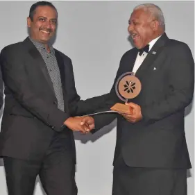  ?? Waisea Nasokia. ?? Fiji Airports acting chief executive officer Faiz Khan receives the Excellence in Business Leadership Award from Prime Minister Voreqe Bainimaram­a at the Sheraton Fiji Resort on November 16, 2019. Photo: