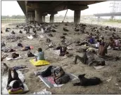  ?? AP ?? Homeless people sleep in the shade of an over-bridge to beat the heat wave in New Delhi, Friday. An intense
heat wave has been sweeping through South Asia.