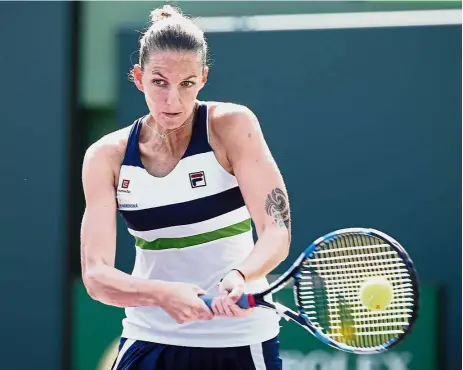  ?? — AP / AFP ?? Easy peasy: Karolina Pliskova returning a shot to Madison Brengle in the second round of the Miami Open in Florida on Thursday. Below: Agnieszka Radwanska in action against Wang Qiang in the second round. Radwanska won 7- 6, 6-1.
