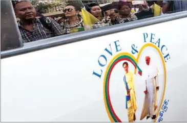  ?? YE AUNG THU/AFP ?? A sticker of Myanmar’s State Counselor Aung San Suu Kyi (left) and Pope Franics is displayed on a car in downtown Yangon, after the pope’s arrival to Myanmar for a four-day official visit yesterday.