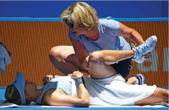  ?? PAUL KANE/GETTY IMAGES ?? Eugenie Bouchard receives courtside treatment during her Hopman Cup singles match on Friday.