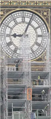  ??  ?? Workmen erect scaffoldin­g around the clockface of Elizabeth Tower. The tower is currently undergoing a four-year renovation plan