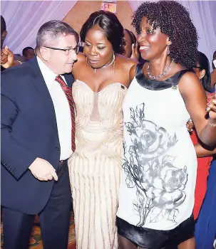  ??  ?? The champion, Jardine Vassell (centre), being escorted to the stage by general manager of Beaches Ocho Rios Charles Blacher and the first Sandals Ultimate awardee, Patricia Bucknor-Cox.