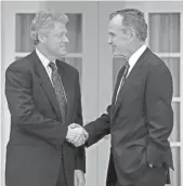  ??  ?? President George H.W. Bush shakes hands with President-elect Bill Clinton at the White House before an Oval Office meeting on Nov. 18, 1992.