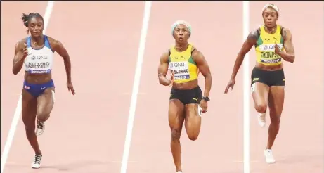  ??  ?? Jamaica’s Shelly Ann Fraser-Pryce centre storming her way to yet another 100m World Championsh­ips gold medal.