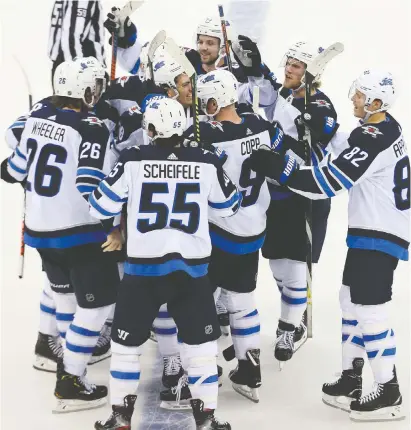  ?? TODAY SPORTS JOE CAMPOREALE/USA ?? The Winnipeg Jets celebrate against the New Jersey Devils after the shootout at Prudential Center.