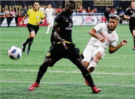  ?? CURTIS COMPTON / CCOMPTON@AJC.COM ?? Atlanta United forward Josef Martinez scores his 27th goal of the season to tie the MLS record as his club defeated the Columbus Crew 3-1 on Sunday at Mercedes-Benz Stadium.