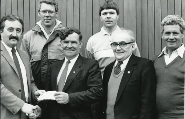  ??  ?? Recently deceased former Louth County Councillor Jim Lennon, who was Louth County Board Chairman at the time accepts a sponsorshi­p cheque from Jim Lally (first left) and David Lally Snr. of Lally’s Electrical, watched by seniorteam selecors to manager,...